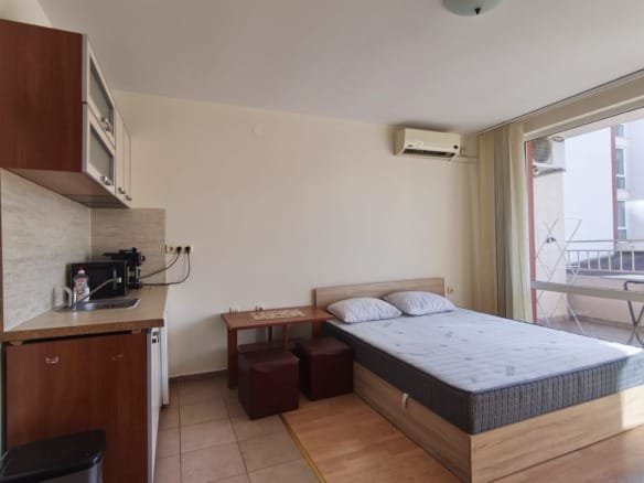 Современная студия с kitchenette, двуспальной кроватью и балконом, идеальная для жизни или аренды в Болгарии.