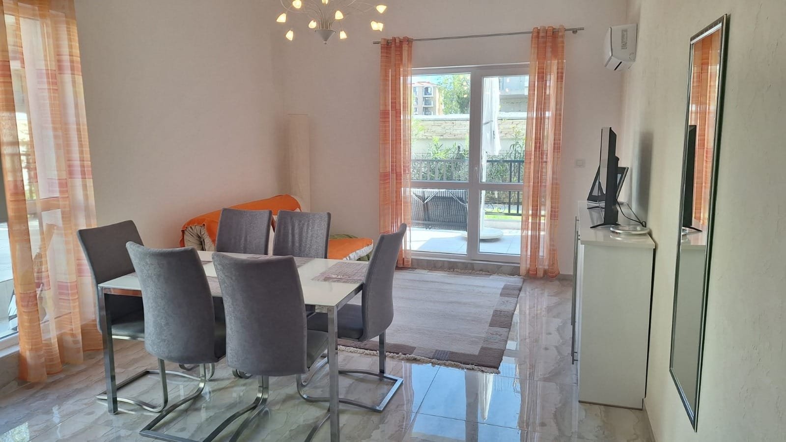 Современный интерьер квартиры в Болгарии с обеденным столом, стульями и светлым оформлением. Добавлены элементы комфорта и стиля.