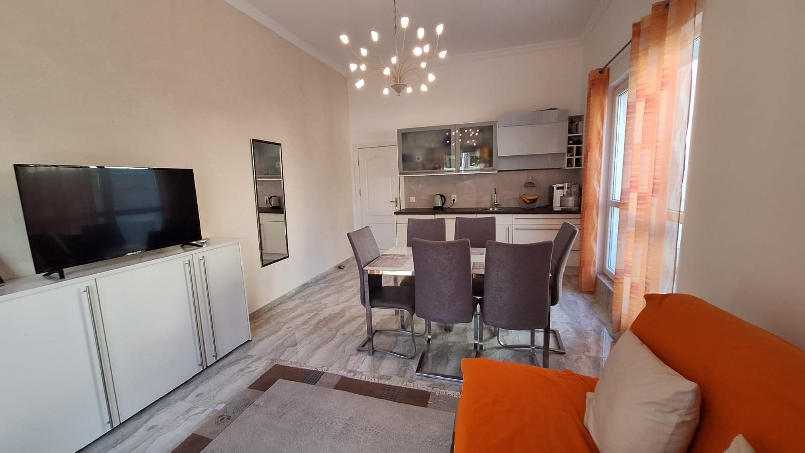 Современная квартира в Болгарии с уютной мебелью, светлым интерьером и обеденной зоной, идеальная для жизни или аренды.