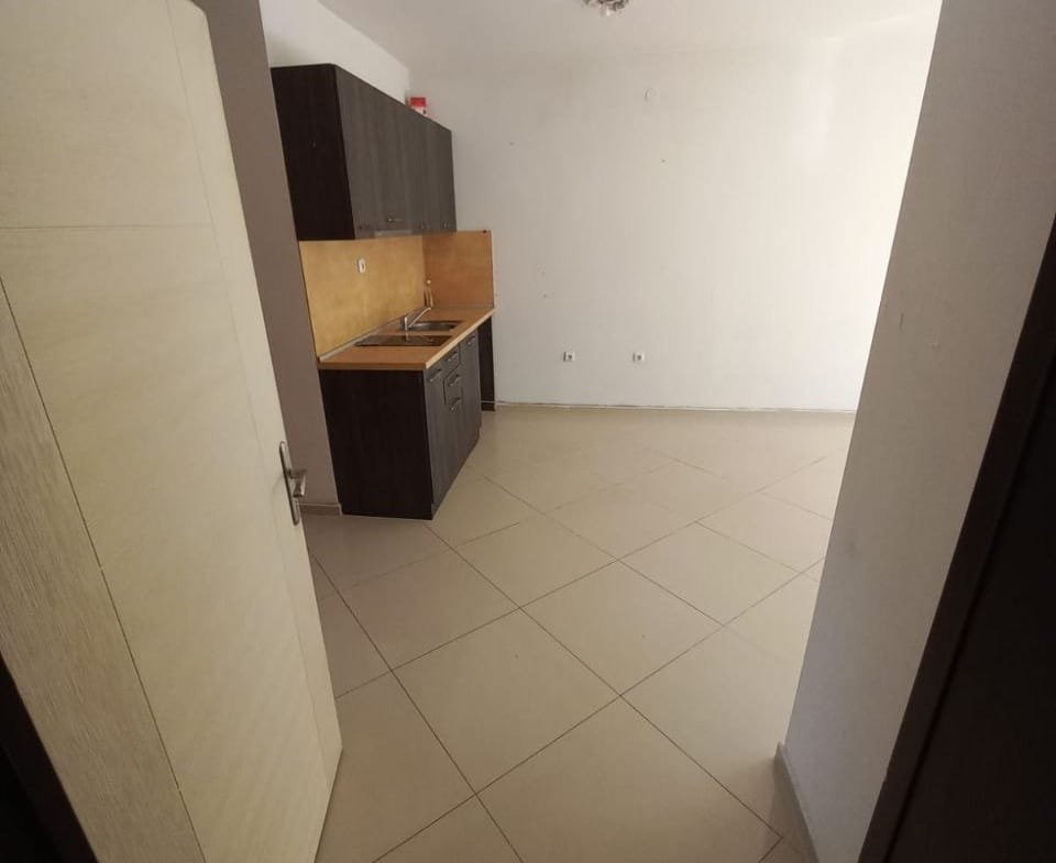 Современная кухня в квартире в Болгарии, светлые стены, плиточный пол, местом для размещения бытовой техники.