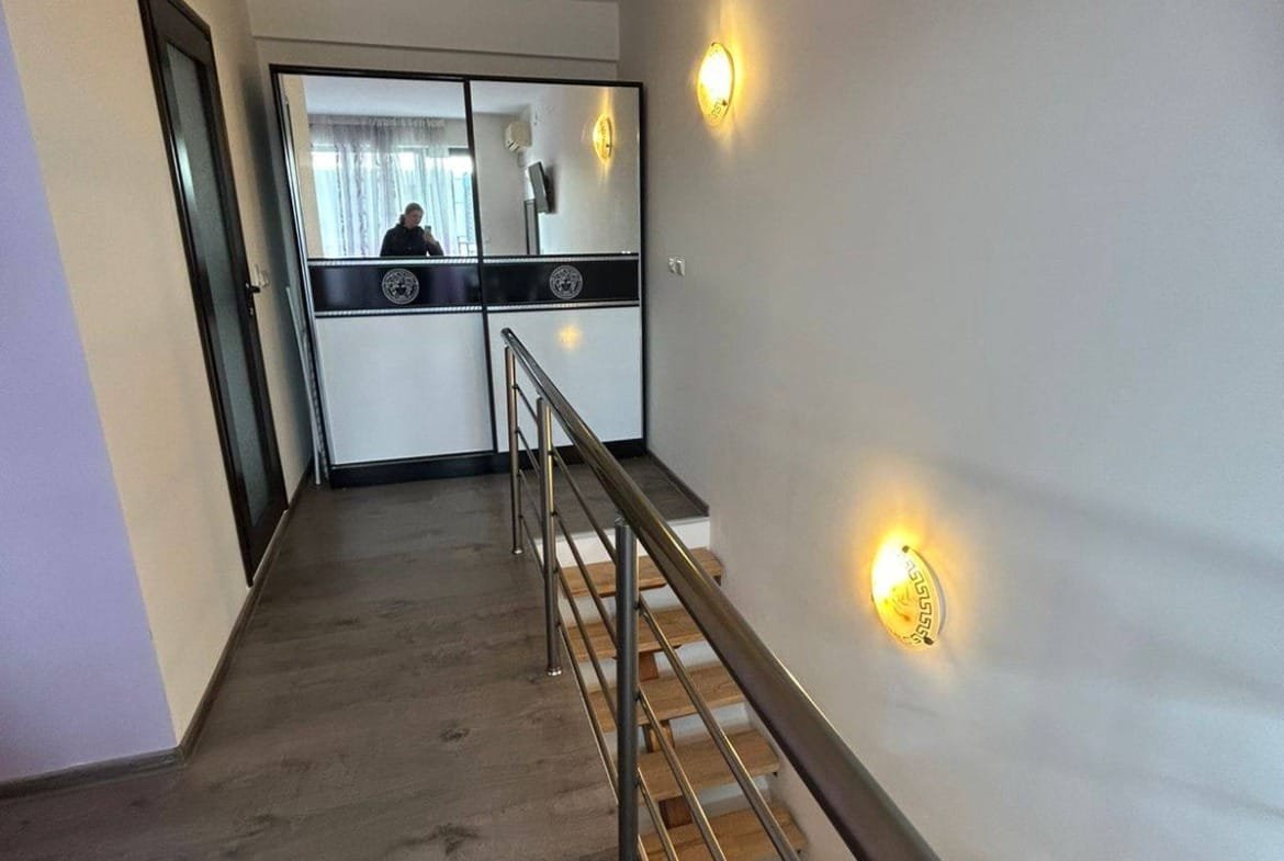 Современный интерьер коридора с лестницей, стеклянной перегородкой и светильниками, идеальный для продажи недвижимости в Болгарии.