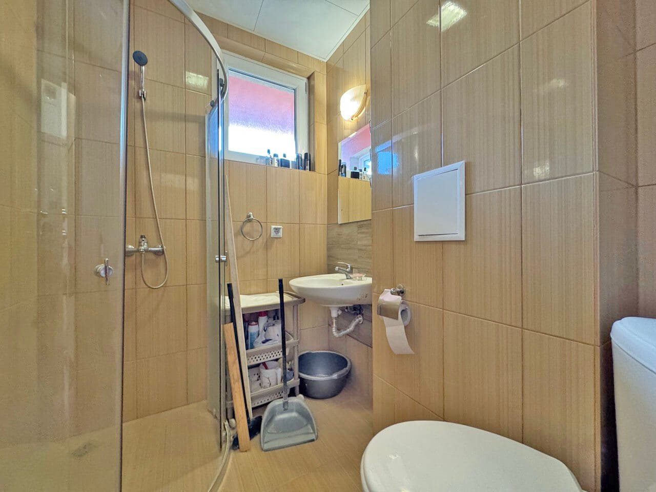 Современная ванная комната с душевой кабиной и стильной сантехникой, идеальна для апартаментов у моря в Болгарии.